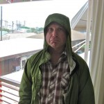 photo of Mike wearing a raincoat inside