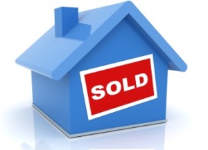 blue house with red SOLD sign