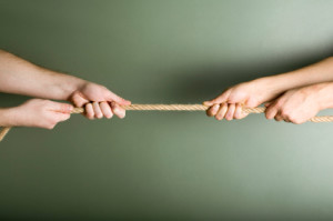hands tugging on opposite ends of a rope