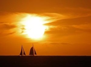 Photo of a sunset in Hawaii with sailboats